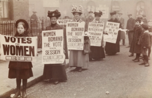 TODAY IN HISTORY - 10th Oct, 2026 - ORBITS NEWS women stand in gutter for a poster parade organised by the womens freedom league to promote the suffrage message c museum of london
